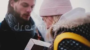 在一个下雪的元旦，一个快乐英俊的年轻人给他的女朋友一个节日礼物盒的特写镜头。
